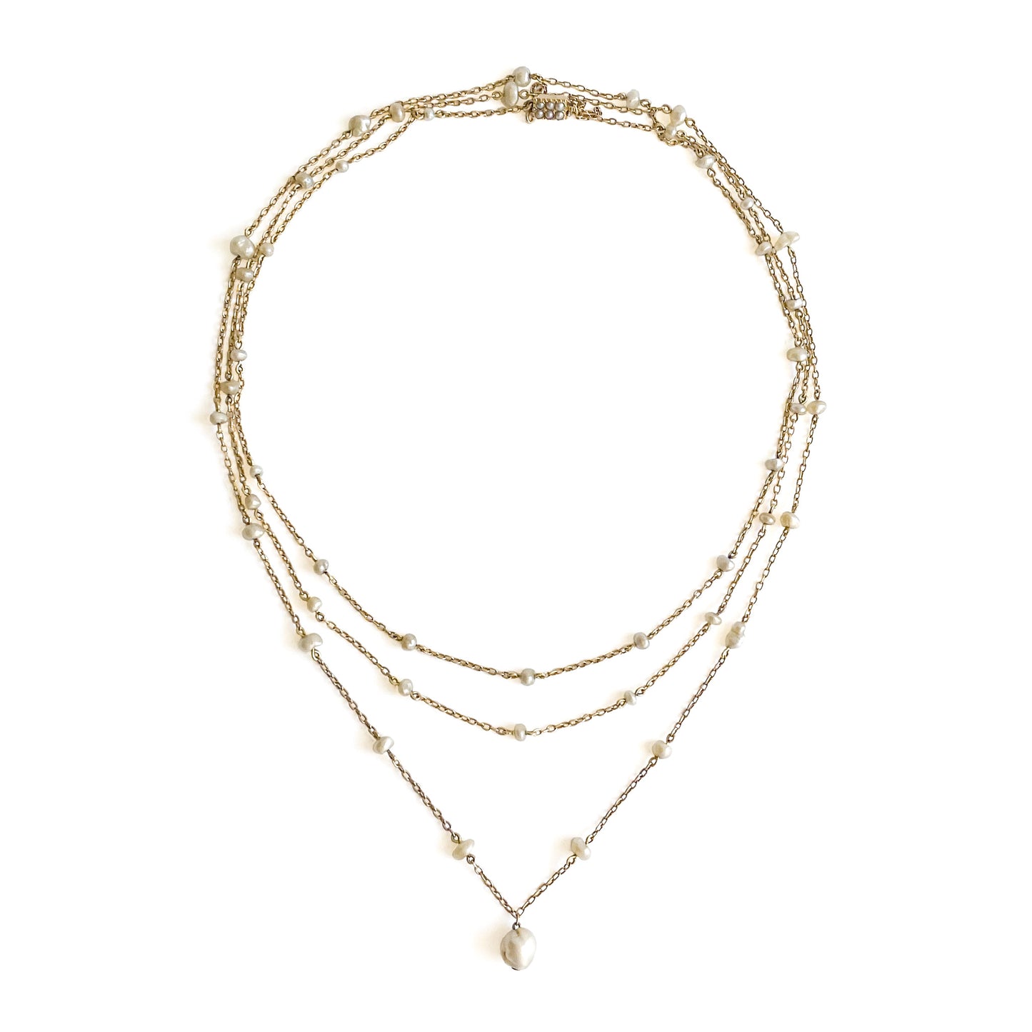 Stunning Edwardian 14ct yellow gold chain interspersed with graduating natural pearls and a larger pearl drop. Clasp attached to safety chain and set with six small seed pearls.