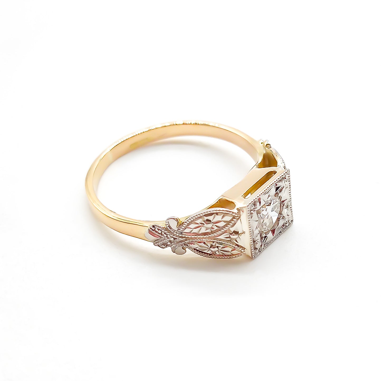 Beautifully engraved Edwardian white and yellow gold ring set with a sparkling 0.35ct old-European-cut centre diamond.