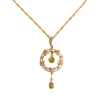 Stunning Edwardian 9ct gold dangling pendant set with two beautifully faceted green peridots and twenty-four tiny seed pearls. On an original 9ct gold fancy link chain. 