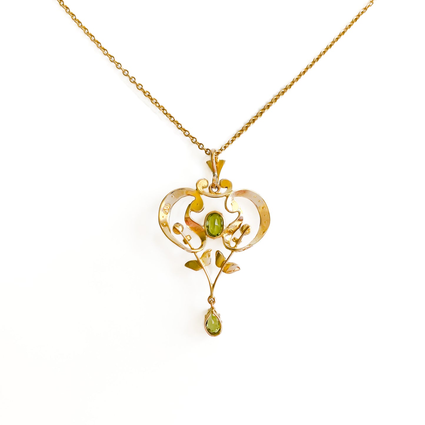 Exquisite Edwardian 9ct yellow gold pendant set with two faceted peridots and twenty-seven seed pearls.