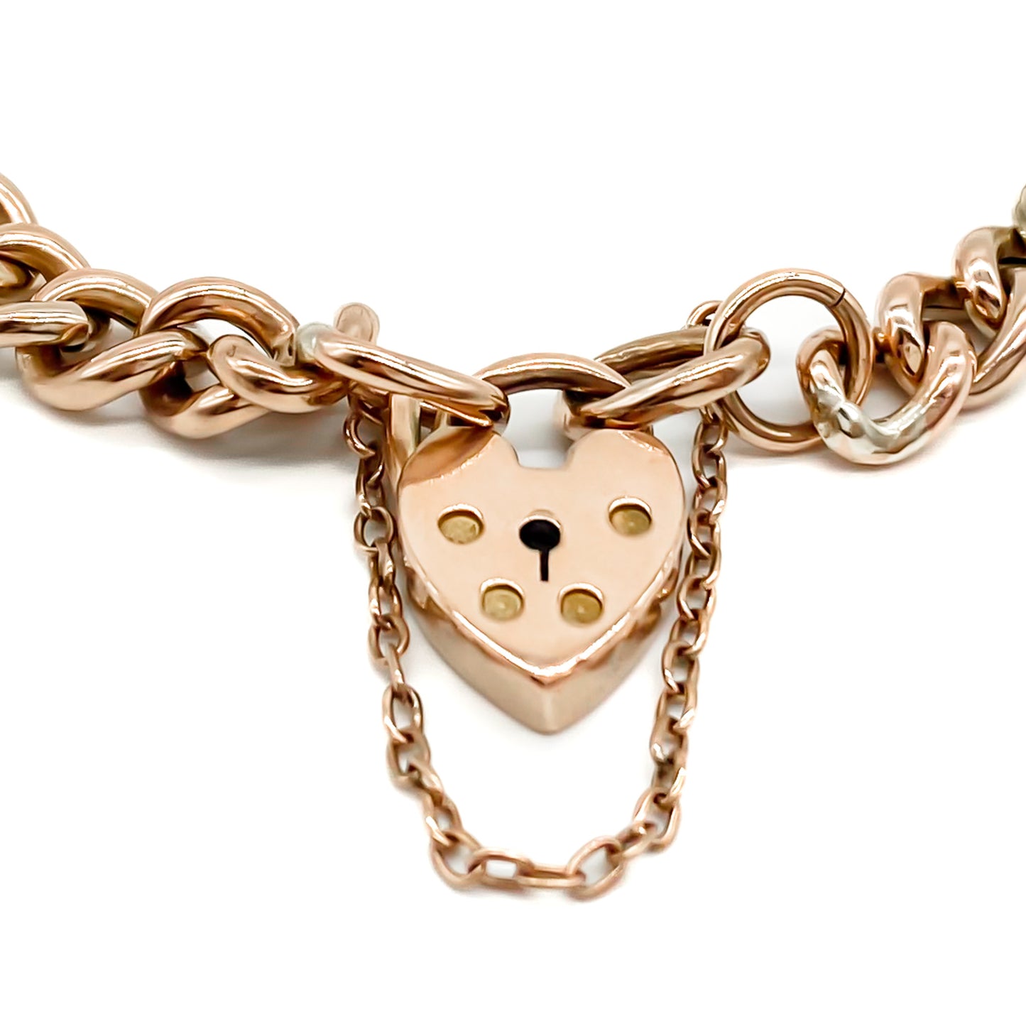 Classic Edwardian 9ct rose gold curb link bracelet with padlock and safety chain.