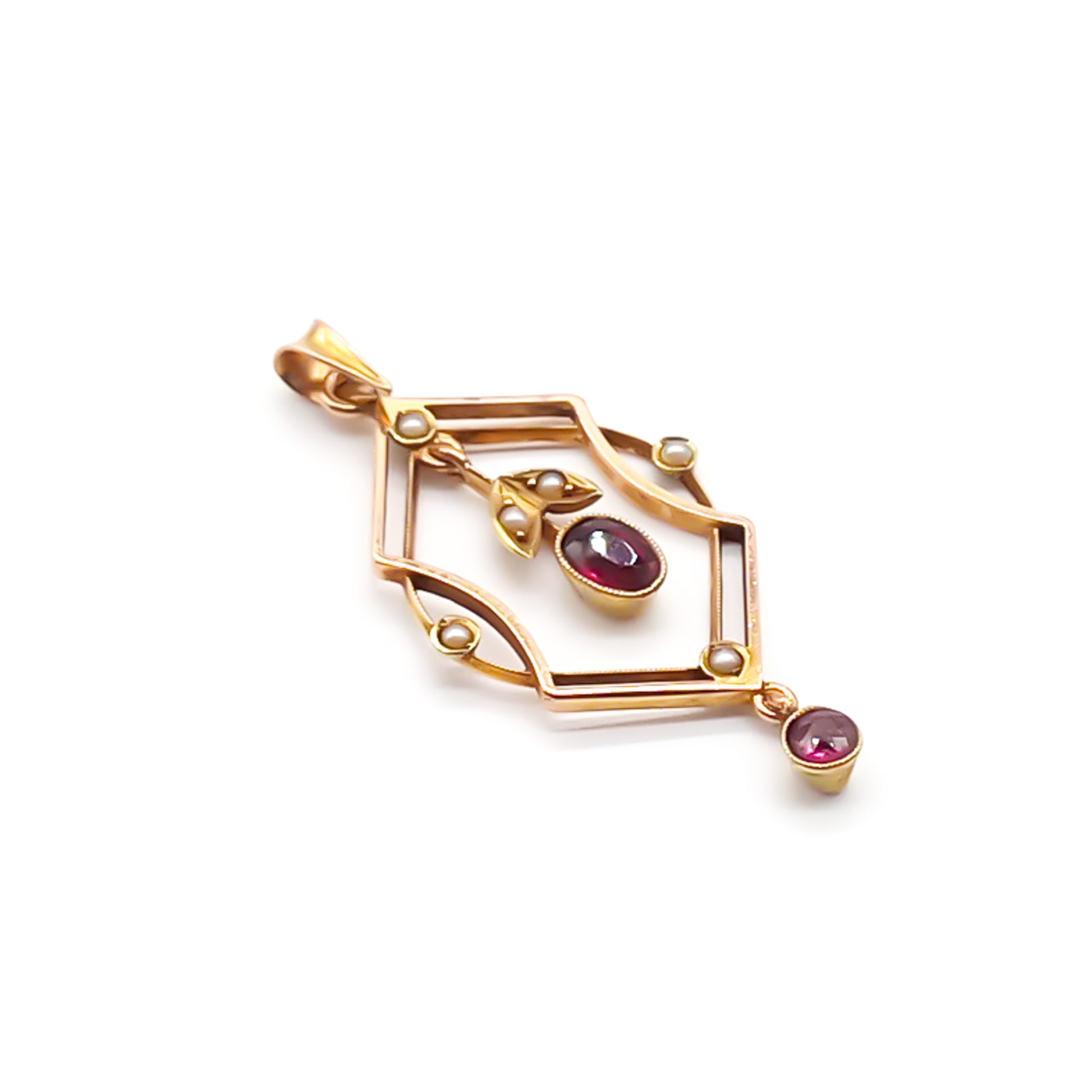 Dainty Edwardian 9ct rose gold pendant set with six seed pearls and two faceted garnet drops.