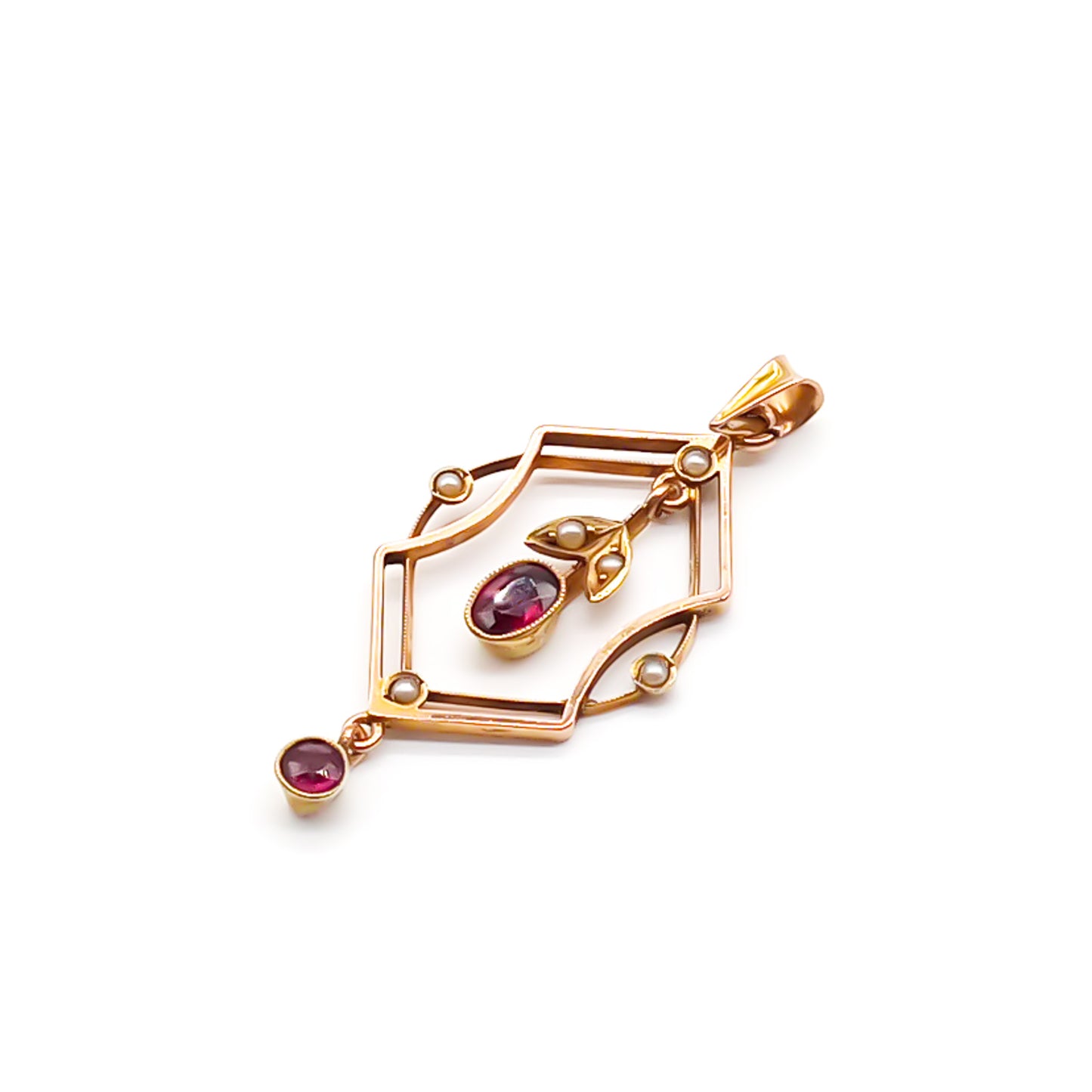 Dainty Edwardian 9ct rose gold pendant set with six seed pearls and two faceted garnet drops.