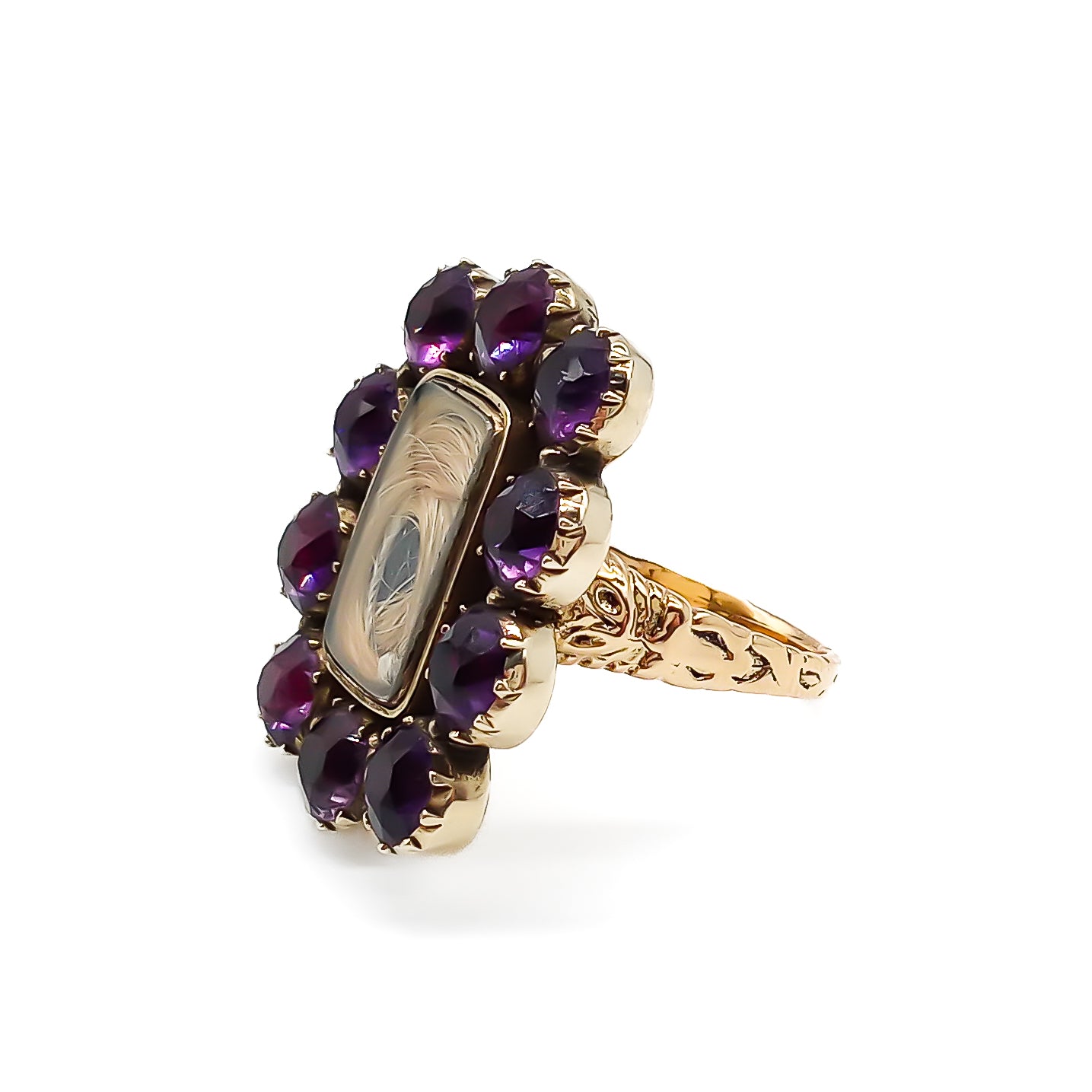 Gorgeous Georgian mourning ring comprising of a 15ct yellow gold setting with hair under glass, surrounded by ten deep purple amethysts. Beautifully engraved later shank.
