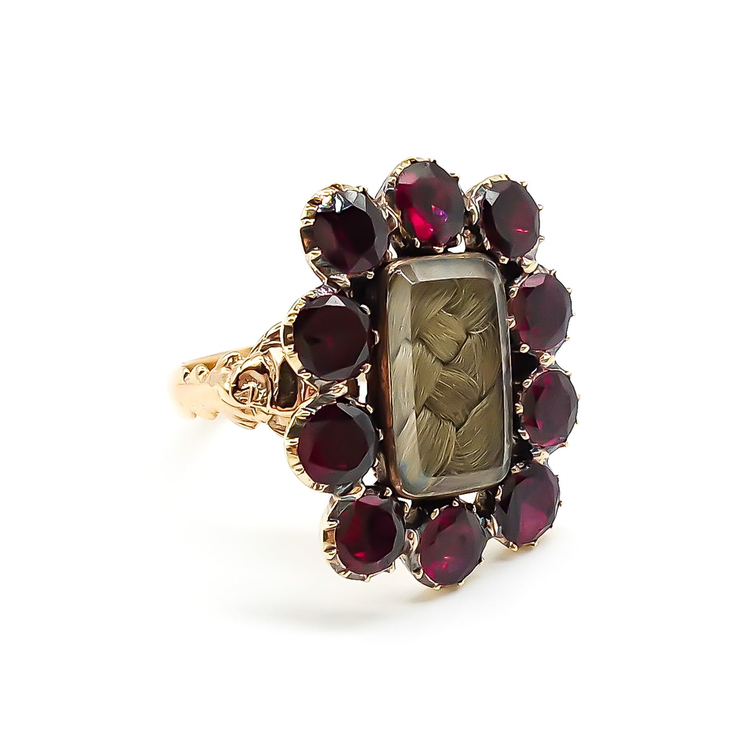 Stunning Georgian mourning ring in a 15ct yellow gold setting with plaited hair under bevelled glass, surrounded by ten beautiful deep red flat cut garnets. Later shank with lovely engraving.