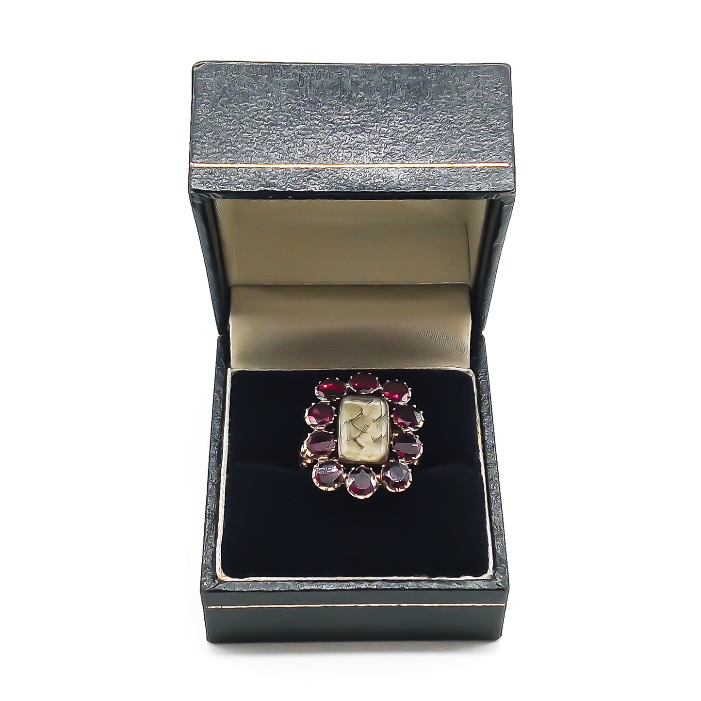 Stunning Georgian mourning ring in a 15ct yellow gold setting with plaited hair under bevelled glass, surrounded by ten beautiful deep red flat cut garnets. Later shank with lovely engraving.