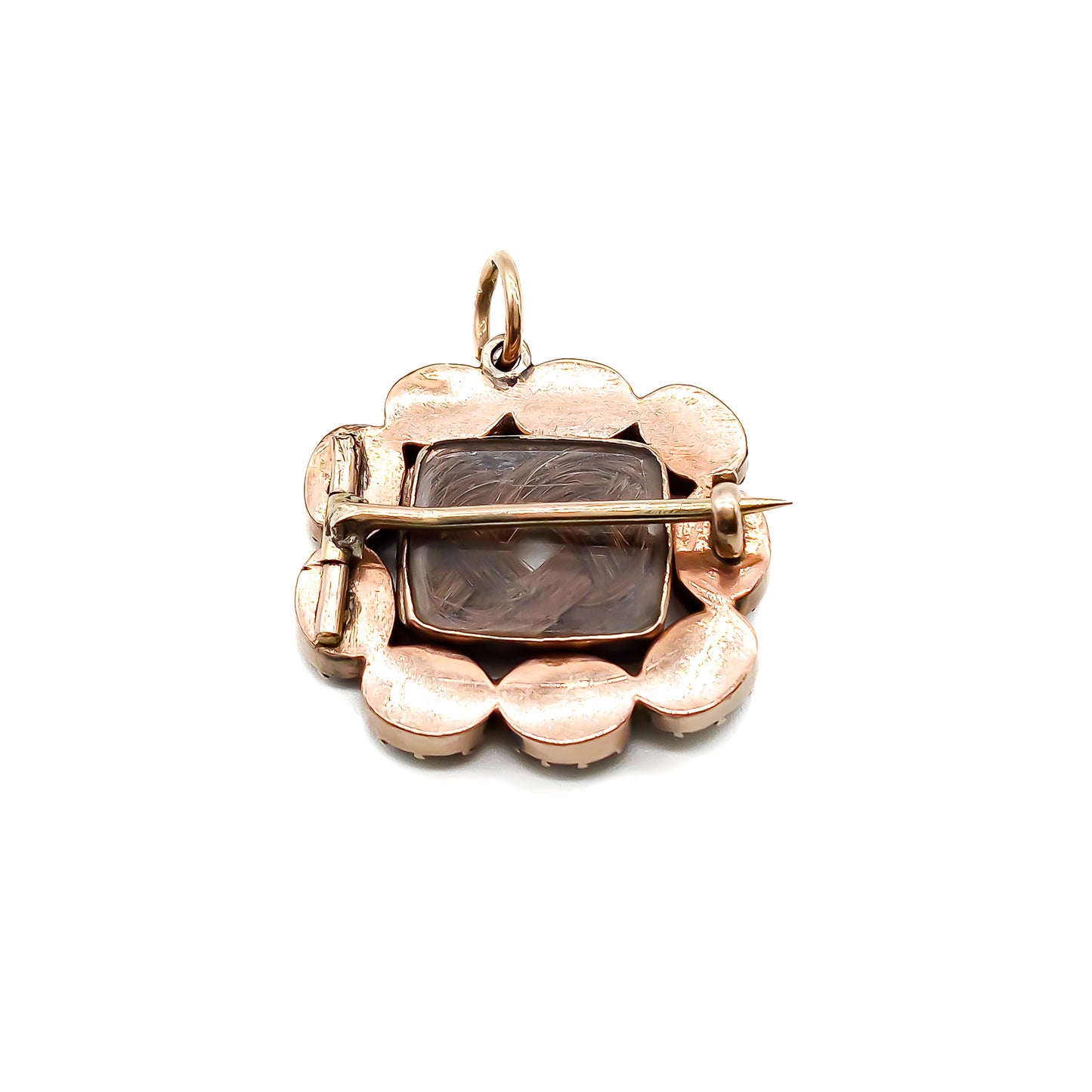 Charming Georgian 9ct rose gold mourning brooch with plaited hair under bevelled glass surrounded by nine Bohemian garnets. 