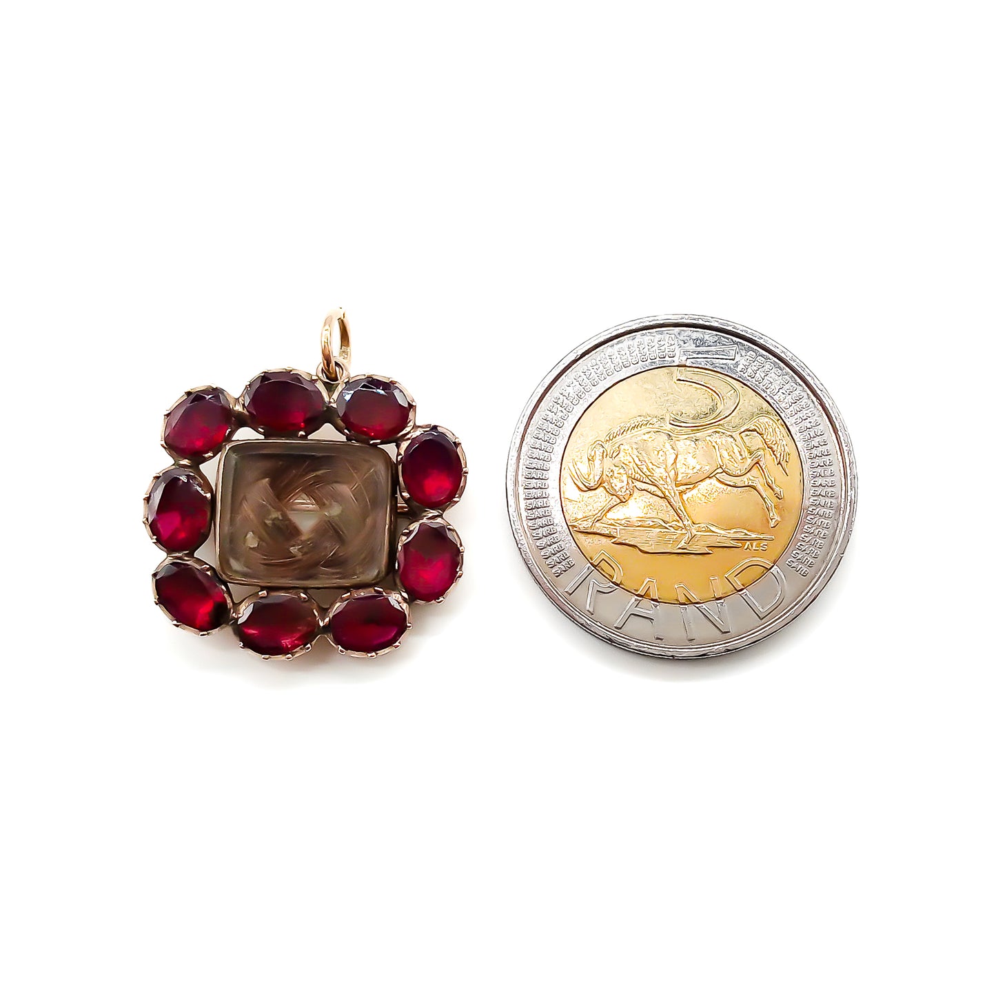 Charming Georgian 9ct rose gold mourning brooch with plaited hair under bevelled glass surrounded by nine Bohemian garnets.