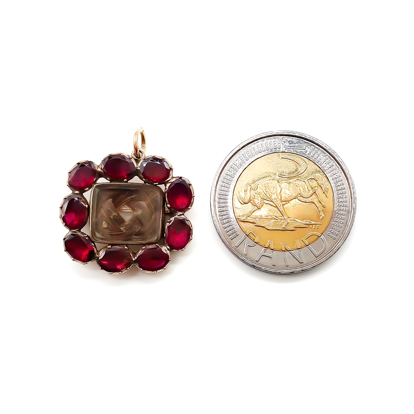 Charming Georgian 9ct rose gold mourning brooch with plaited hair under bevelled glass surrounded by nine Bohemian garnets. 