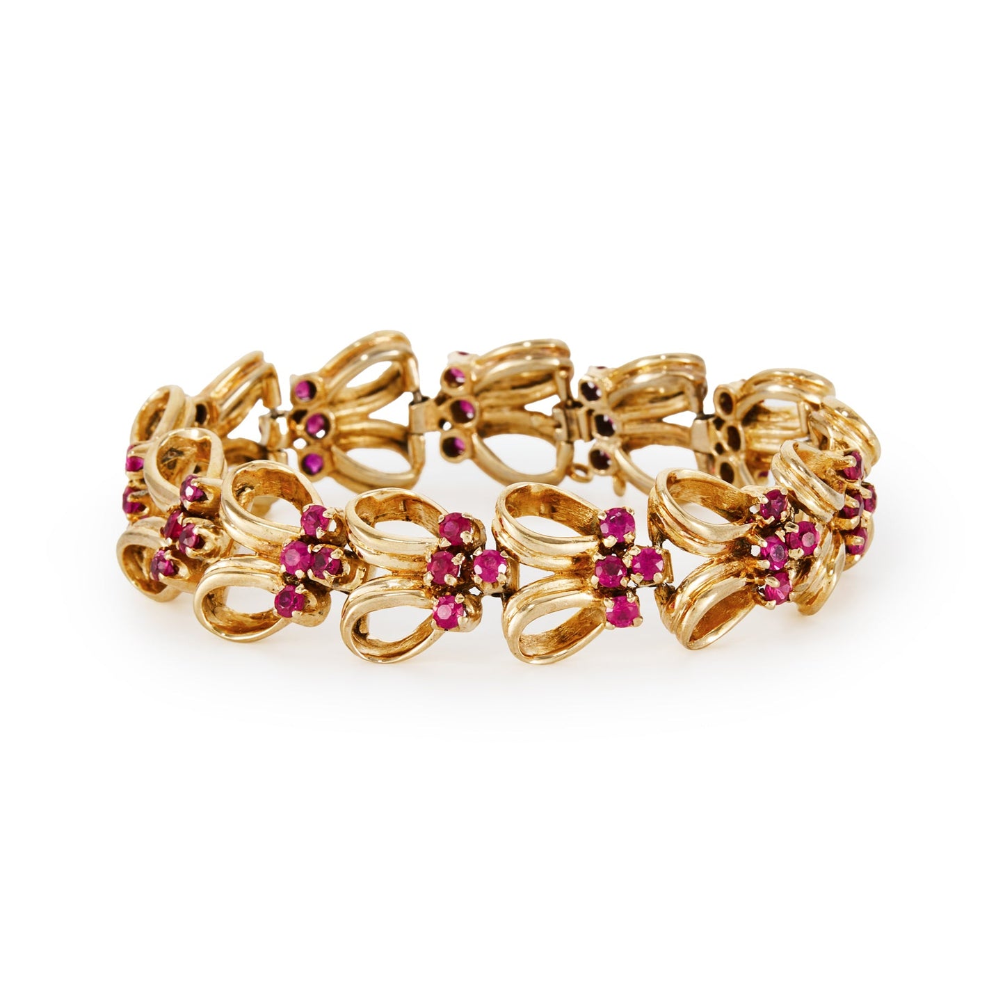 Stylish gold plated on silver articulated bracelet, set with man-made rubies. Signed Norman Hartnell. London 1958.