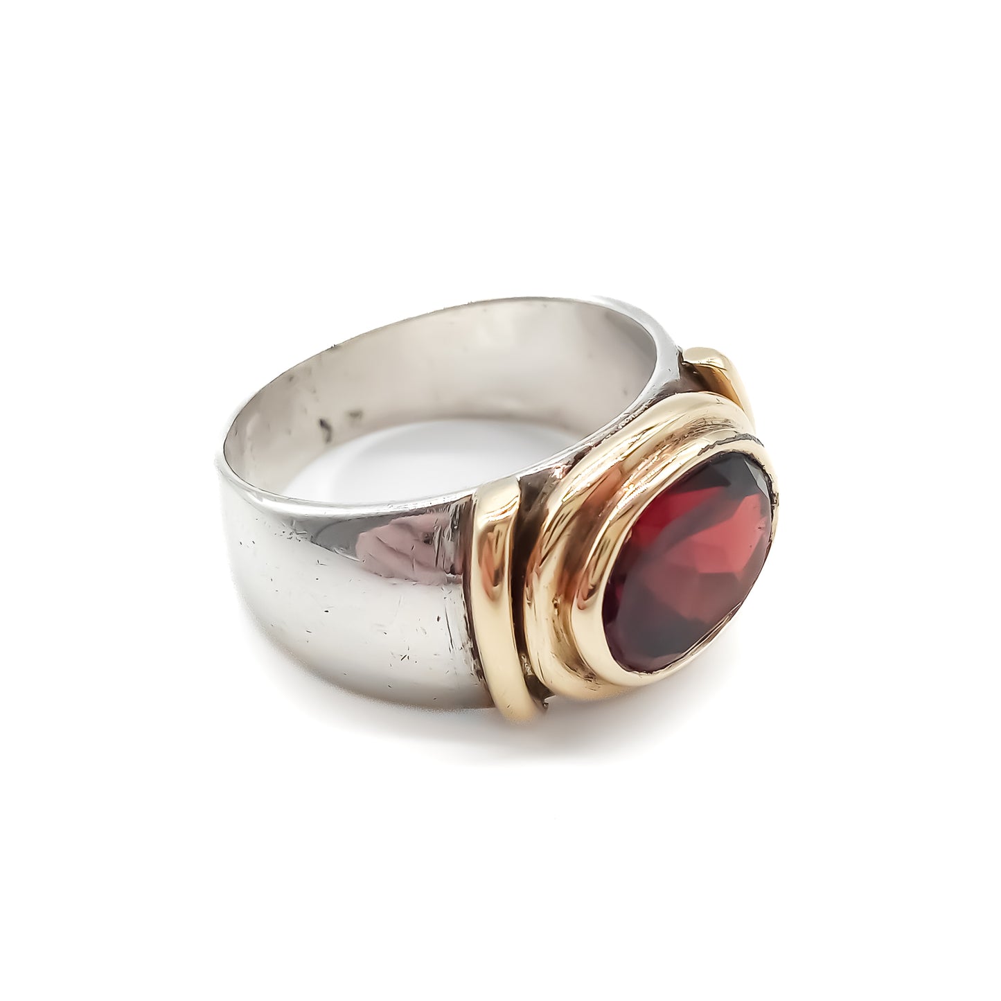 Classic gold and silver ring set with a beautifully faceted deep red oval garnet.
