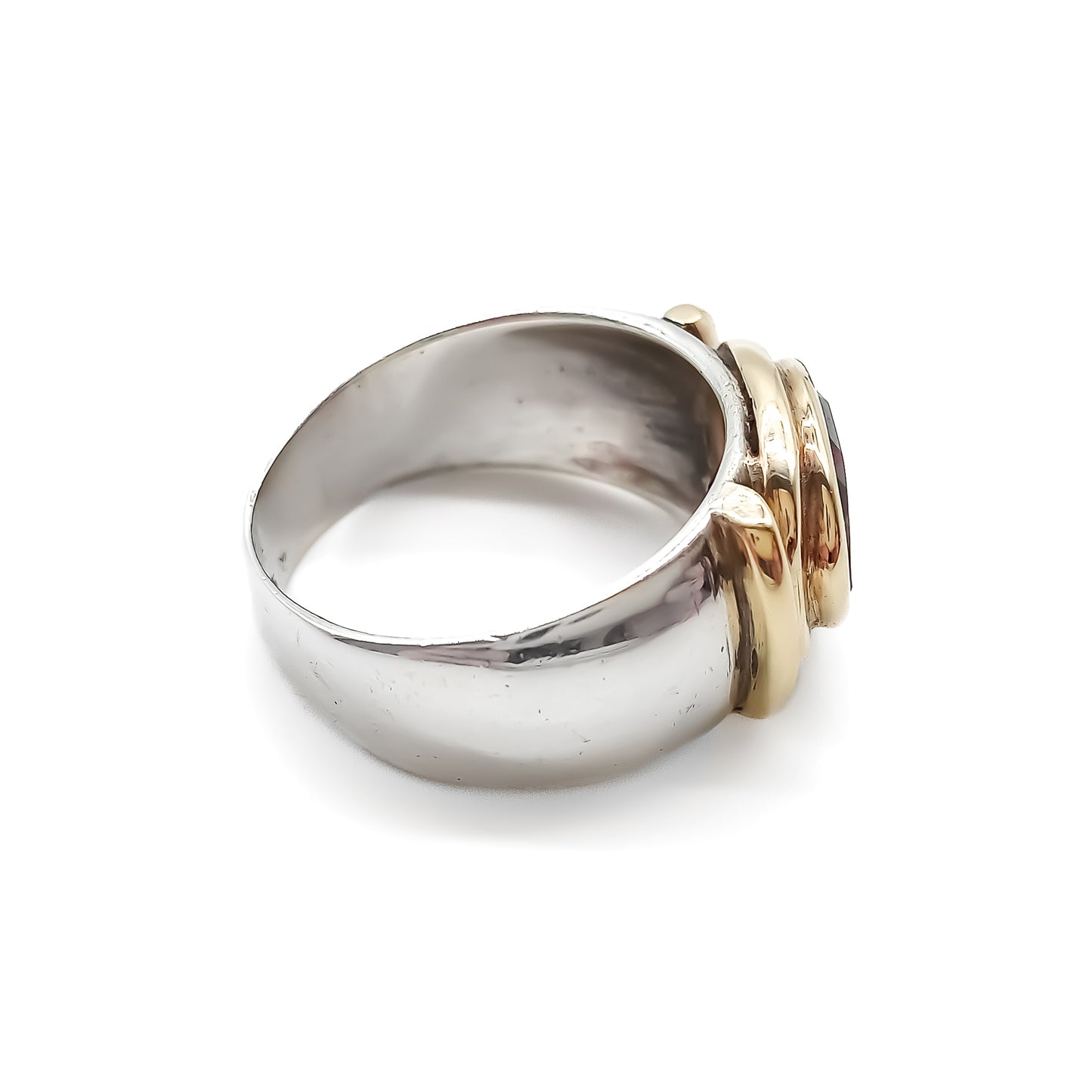 Classic gold and silver ring set with a beautifully faceted deep red oval garnet.