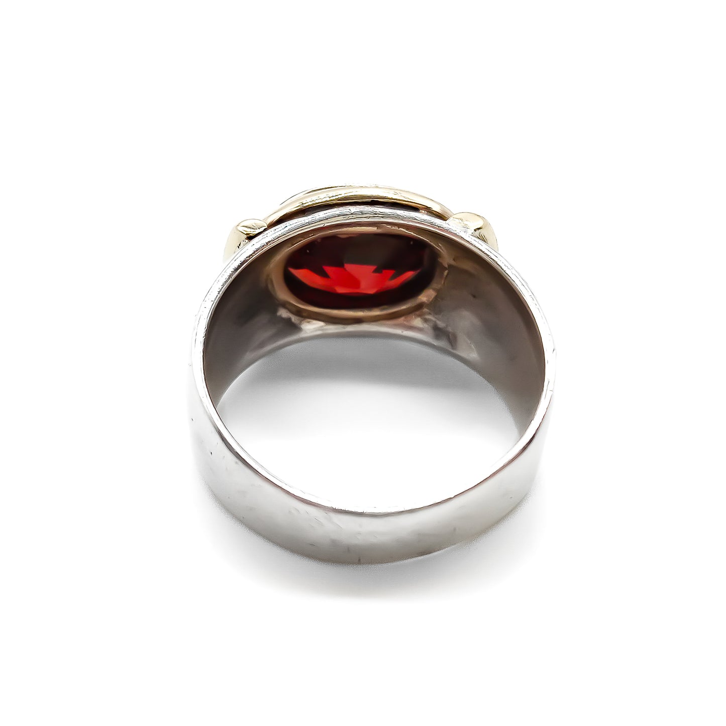 Classic gold and silver ring set with a beautifully faceted deep red oval garnet.