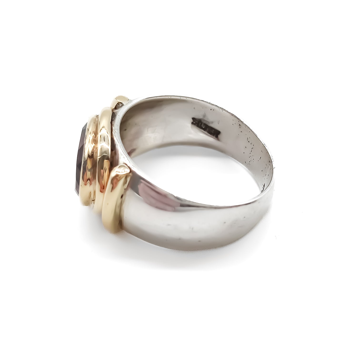 Classic gold and silver ring set with a beautifully faceted deep red oval garnet.