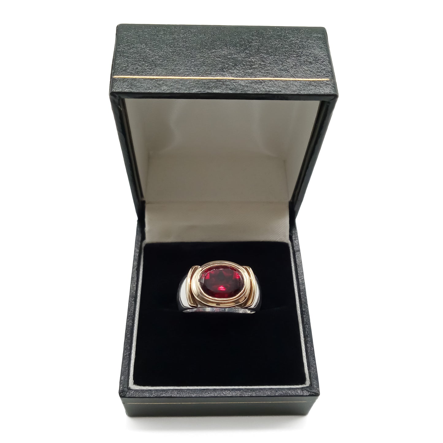 Classic gold and silver ring set with a beautifully faceted deep red oval garnet.