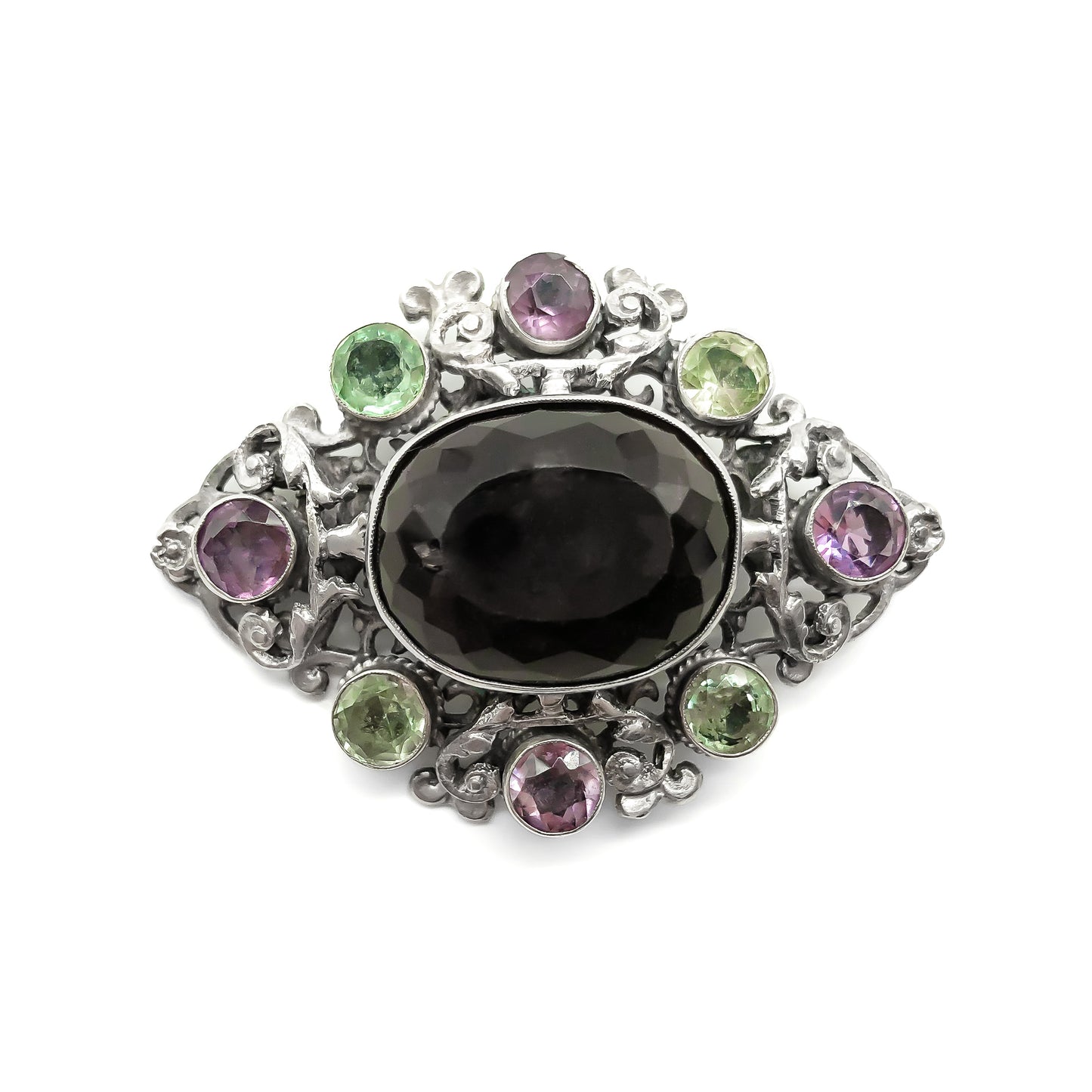 Stunning Arts and Crafts Zoltan White and Co. silver brooch set with a large oval smoky quartz and eight green and purple amethysts. Circa 1920’s