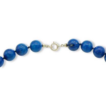Stunning string of bright blue large, golden flecked lapis lazuli beads with a 9ct yellow gold clasp.
