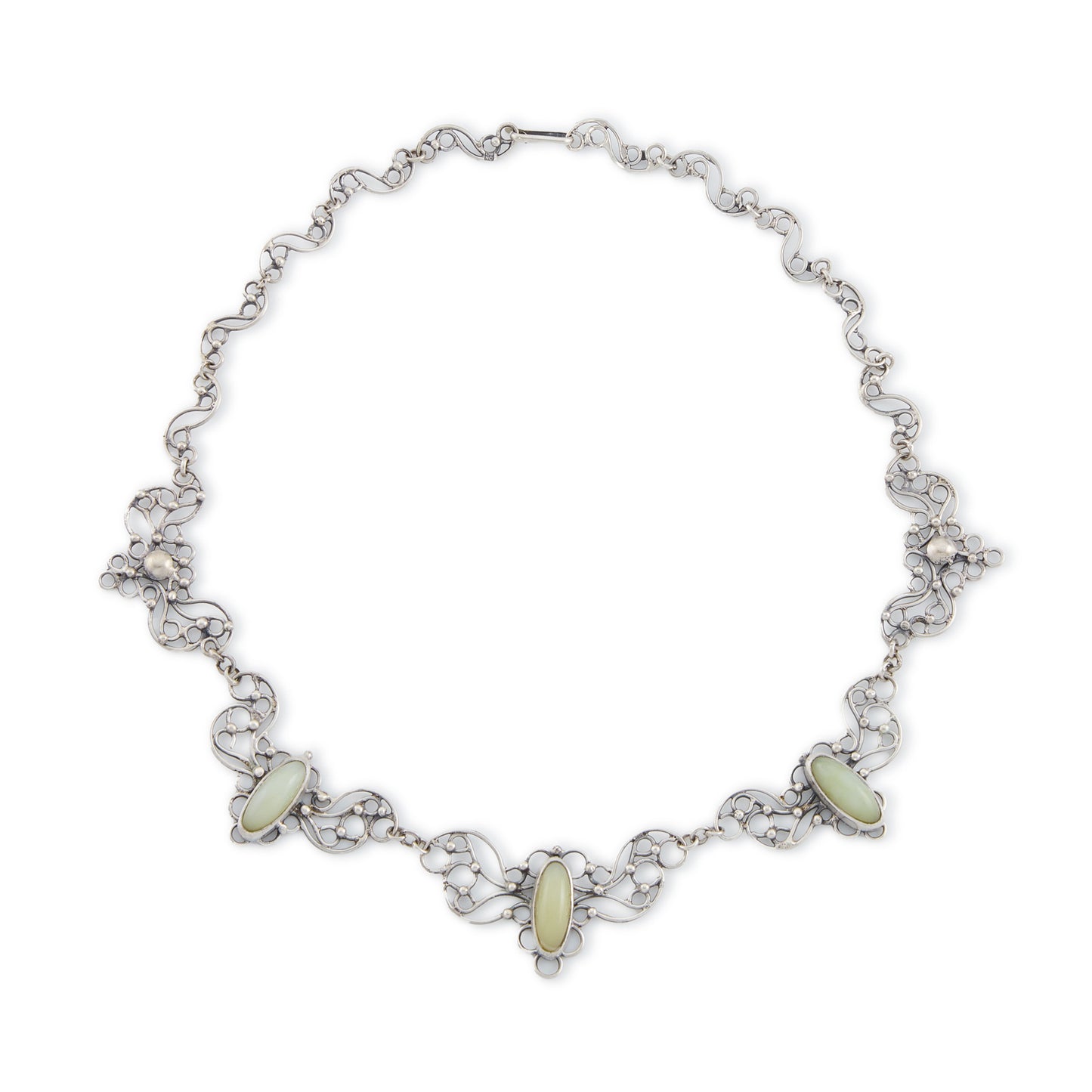Beautiful mid-century silver festoon necklace with some oxidation and ornate detail. Set with three oval green chalcedony cabochon stones. Made in Poland. Company - Orno