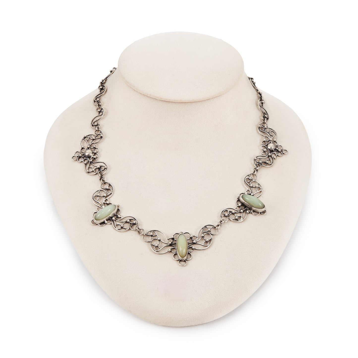 Beautiful mid-century silver festoon necklace with some oxidation and ornate detail. Set with three oval green chalcedony cabochon stones. Made in Poland. Company - Orno