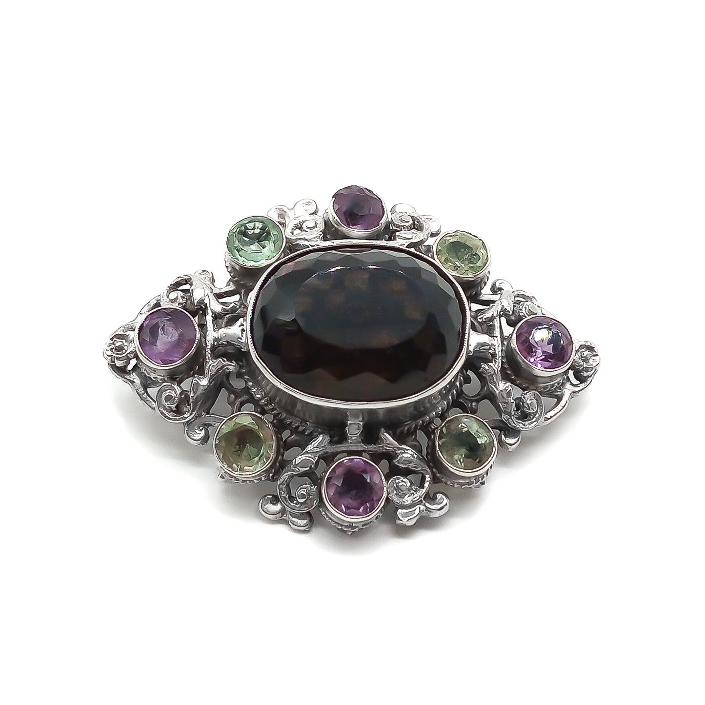 Stunning Arts and Crafts Zoltan White and Co. silver brooch set with a large oval smoky quartz and eight green and purple amethysts. Circa 1920’s