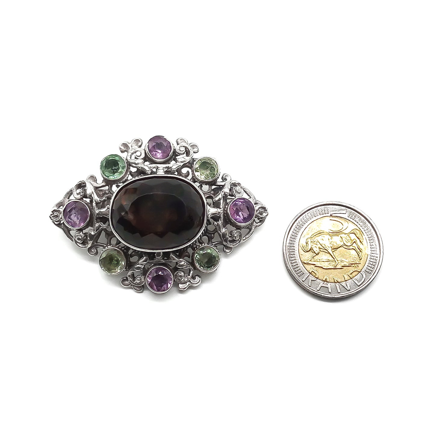 Stunning Arts and Crafts Zoltan White and Co. silver brooch set with a large oval smoky quartz and eight green and purple amethysts. Circa 1920’s