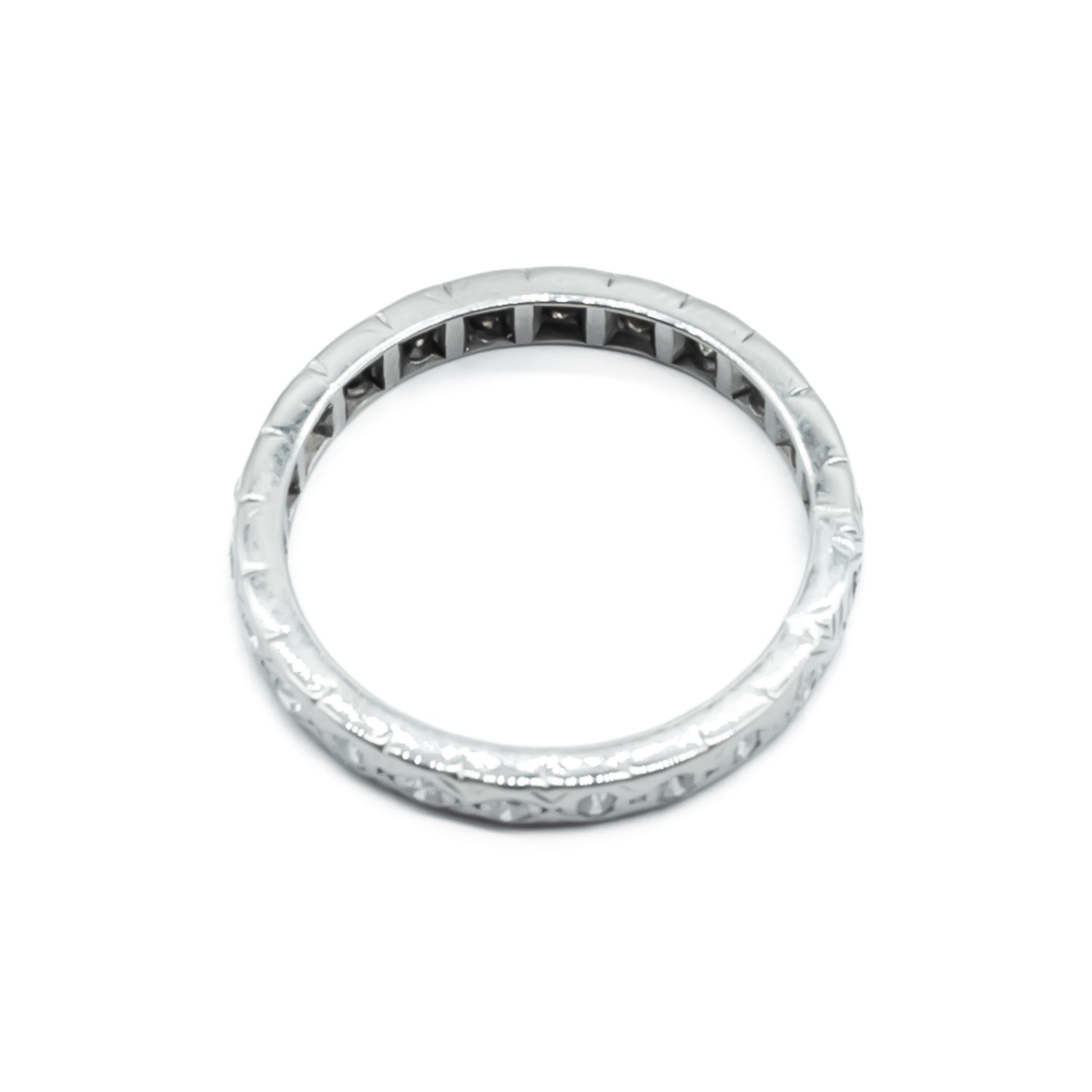 Dainty platinum eternity ring set with twenty-two European-cut diamonds. Circa 1920’s