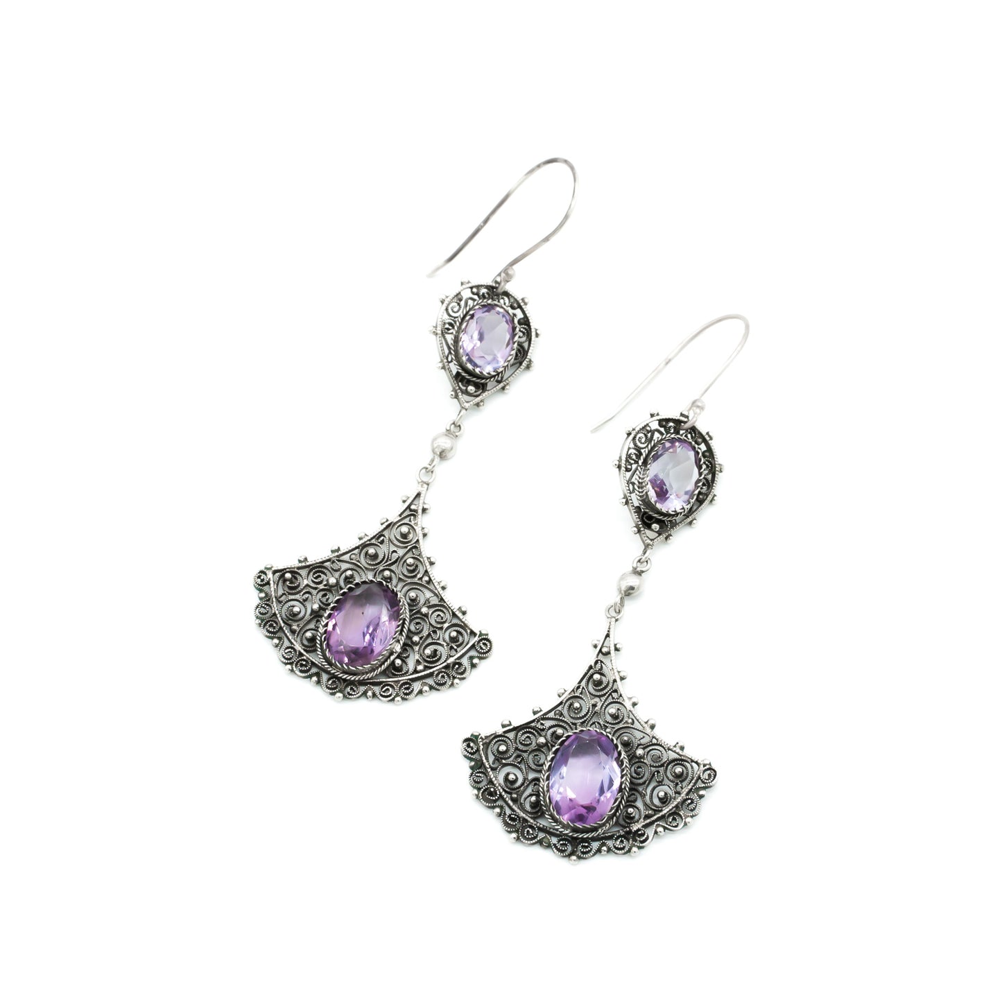 Large silver drop earrings with intricate filigree detail, each set with two beautifully faceted amethysts. Circa 1930’s