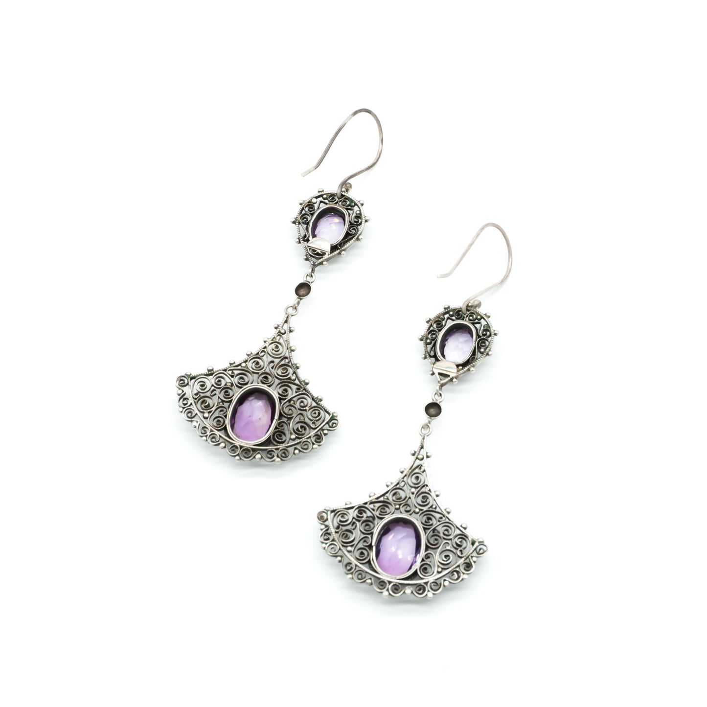 Large silver drop earrings with intricate filigree detail, each set with two beautifully faceted amethysts. Circa 1930’s