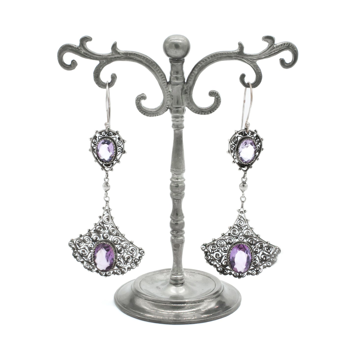 Large silver drop earrings with intricate filigree detail, each set with two beautifully faceted amethysts. Circa 1930’s