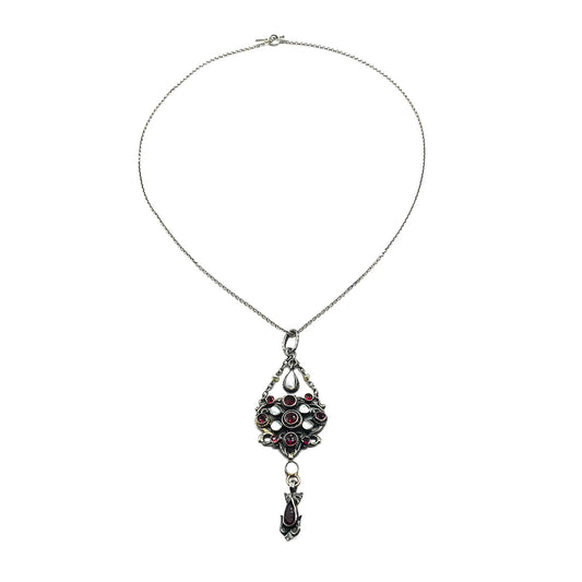 Intricate silver Austro-Hungarian garnet and pearl pendant with dangling drops, on a silver chain.   Circa 1910