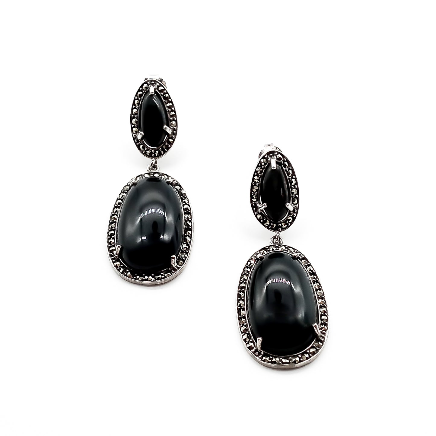 Stylish sterling silver drop earrings, each set with two black tiger’s eye cabochon stones, surrounded by marcasites. Circa 1950’s