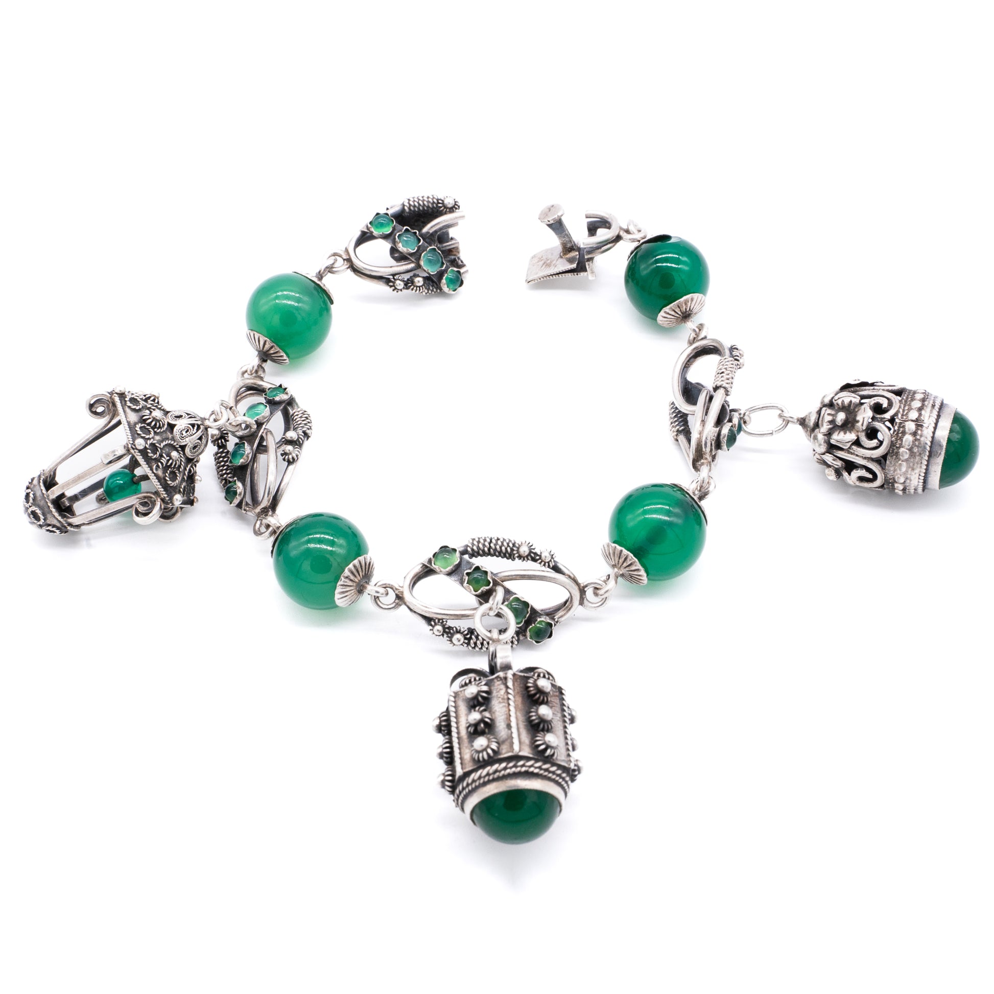 Silver Chrysoprase Magnificent silver filigree charm bracelet with four chrysoprase beads, sixteen chrysoprase cabochons and three intricate charms. Italy. Circa 1930’s