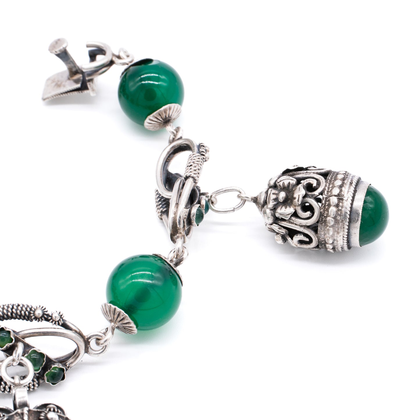 Silver Chrysoprase Magnificent silver filigree charm bracelet with four chrysoprase beads, sixteen chrysoprase cabochons and three intricate charms. Italy. Circa 1930’s