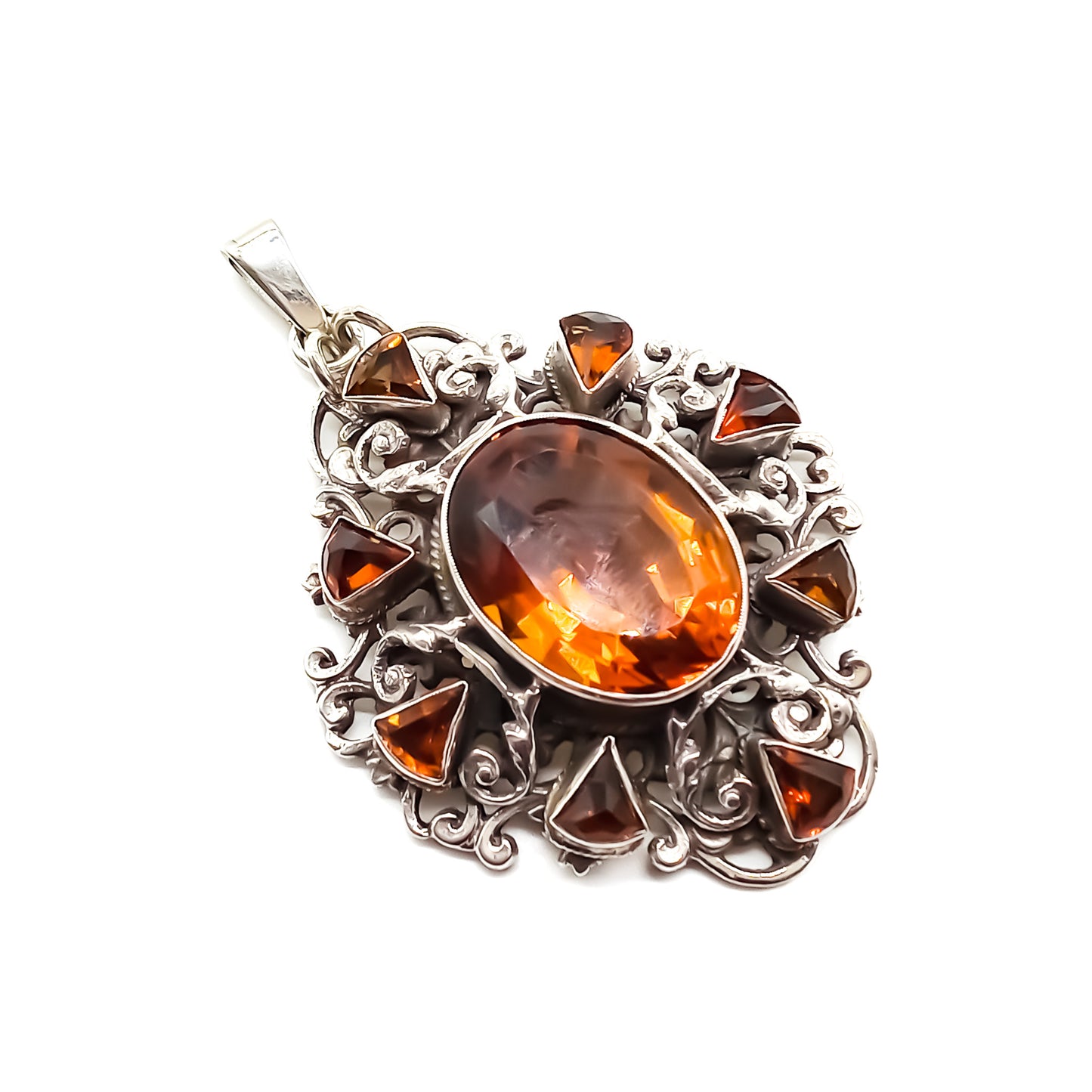 Very ornate sterling silver Arts and Crafts pendant set with a large, beautifully faceted citrine, surrounded by eight small triangular citrines. Circa 1920’s