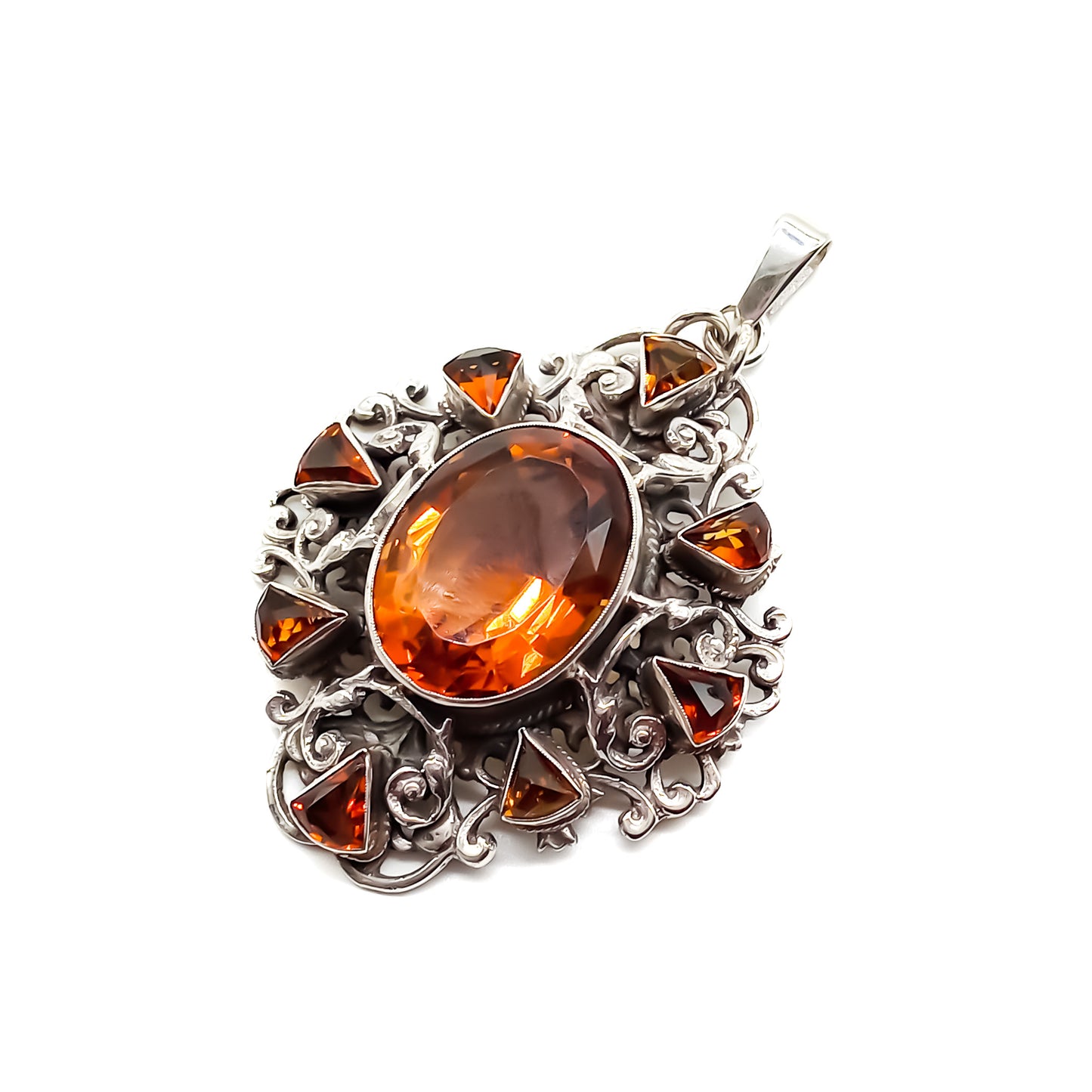 Very ornate sterling silver Arts and Crafts pendant set with a large, beautifully faceted citrine, surrounded by eight small triangular citrines. Circa 1920’s