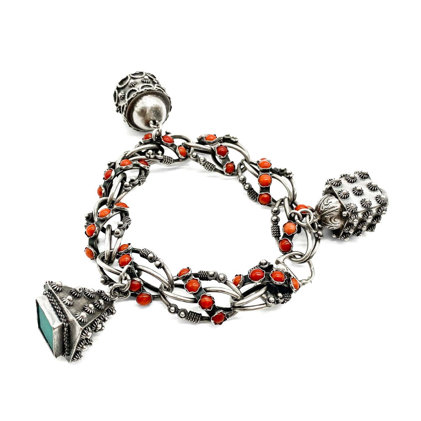 Stunning silver filigree bracelet set with thirty-six natural coral cabochons and three large charms set with coral, moonstone and chrysoprase. Italy