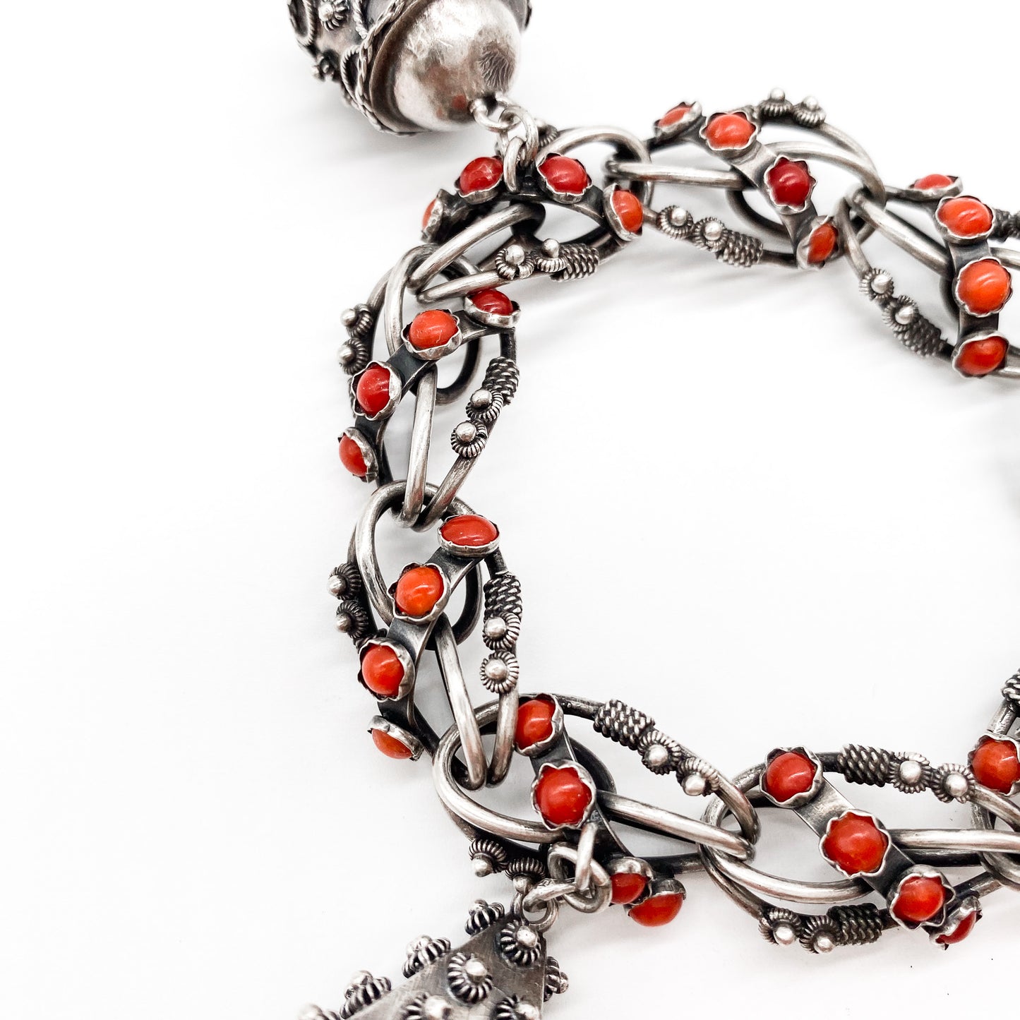 Stunning silver filigree bracelet set with thirty-six natural coral cabochons and three large charms set with coral, moonstone and chrysoprase. Italy