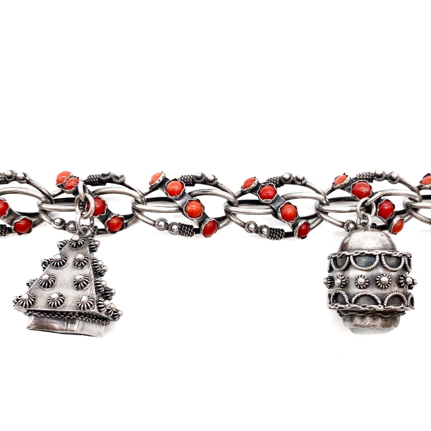 Stunning silver filigree bracelet set with thirty-six natural coral cabochons and three large charms set with coral, moonstone and chrysoprase. Italy