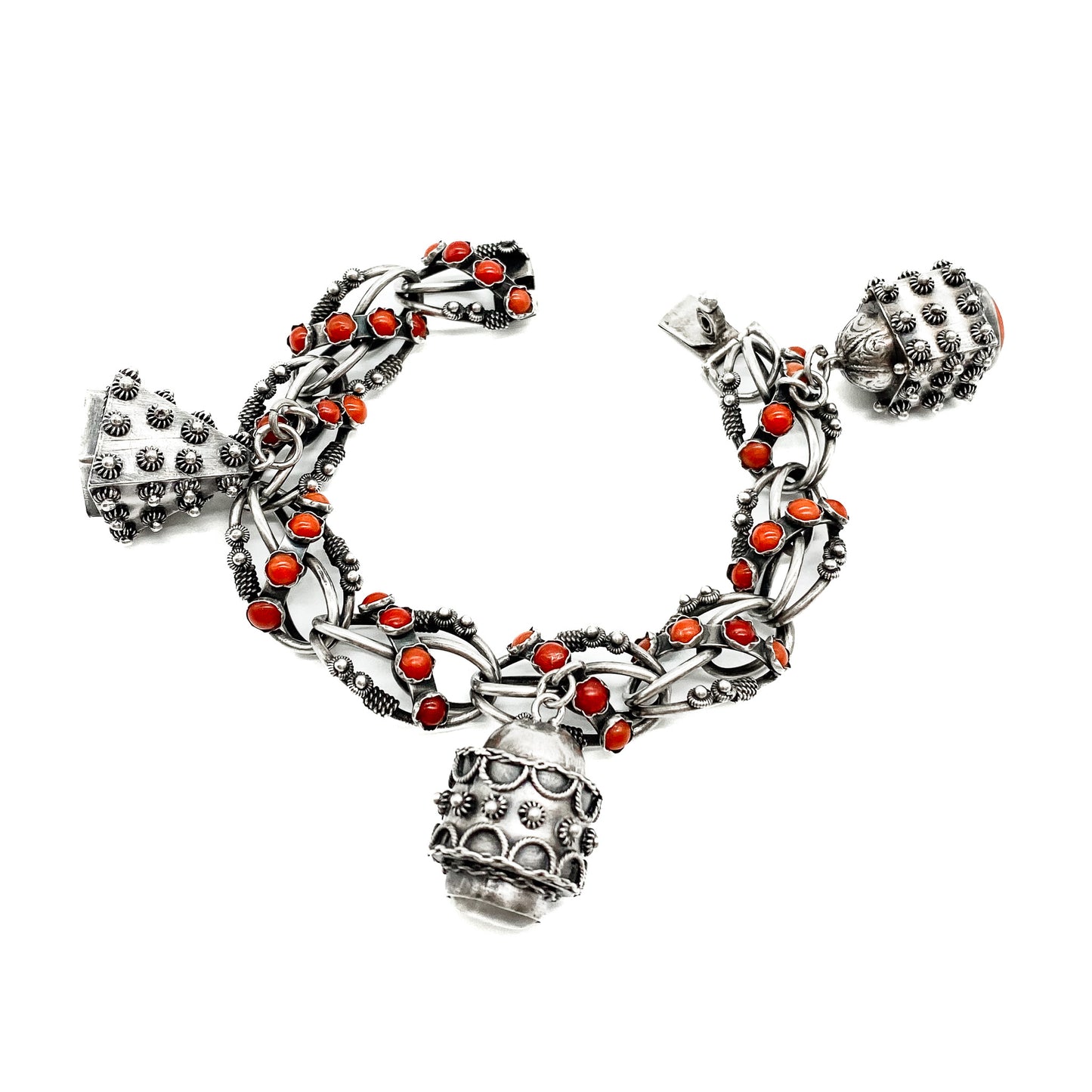 Stunning silver filigree bracelet set with thirty-six natural coral cabochons and three large charms set with coral, moonstone and chrysoprase. Italy