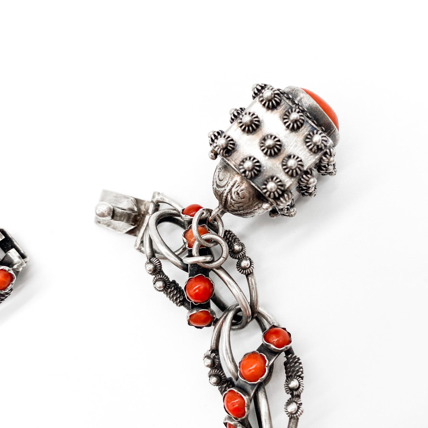 Stunning silver filigree bracelet set with thirty-six natural coral cabochons and three large charms set with coral, moonstone and chrysoprase. Italy