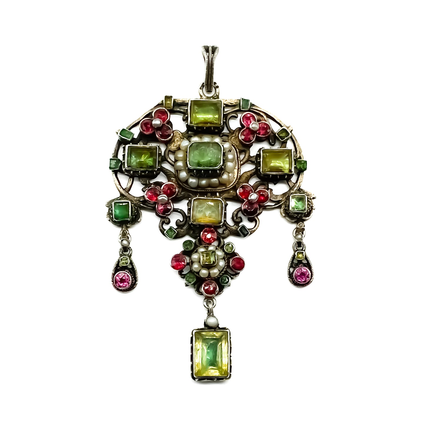 Very ornate silver gilt Austro-Hungarian Festoon pendant set with garnets, seed pearls, emeralds and other green stones. Pendant has beautiful engraving and floral detail. Circa 1890
