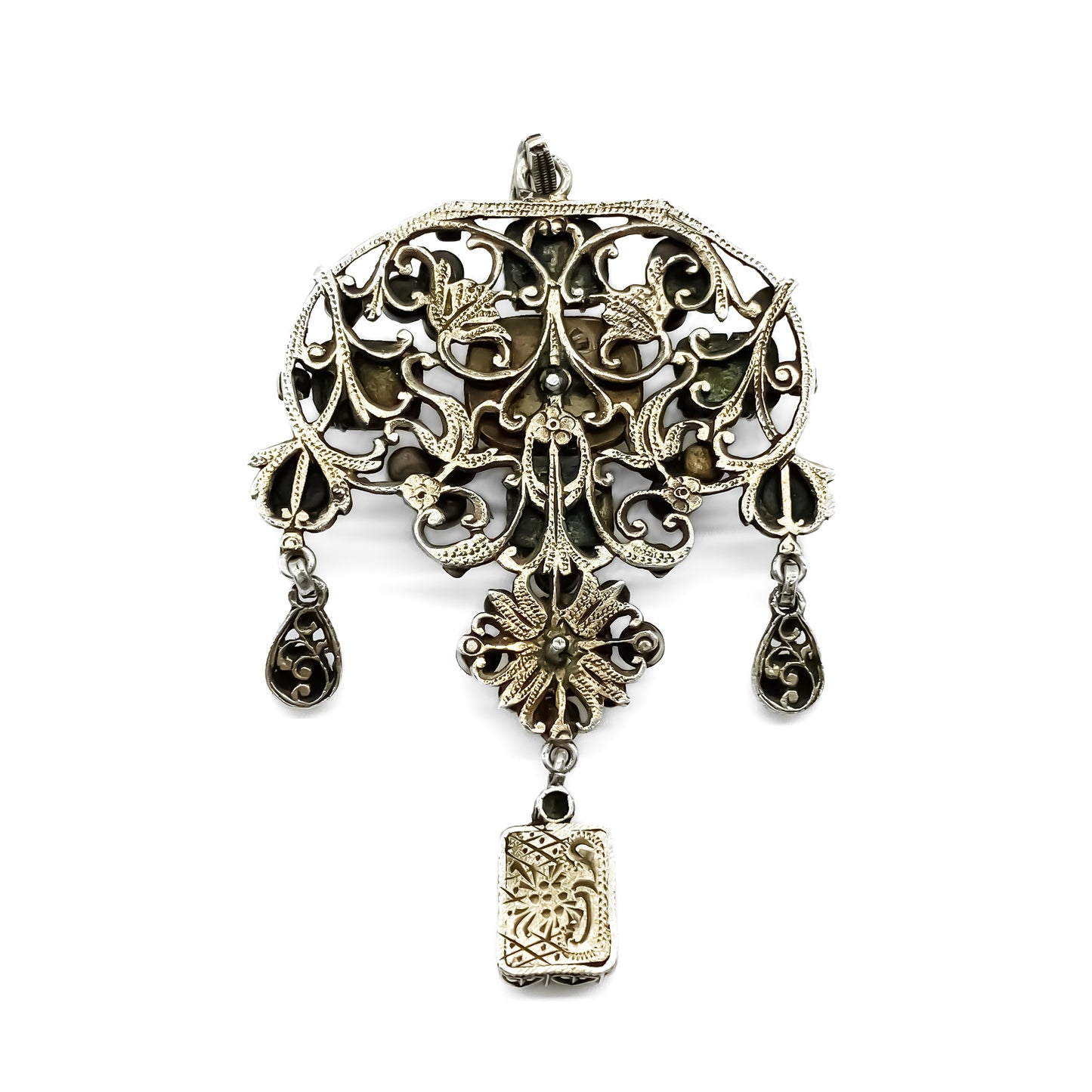 Very ornate silver gilt Austro-Hungarian Festoon pendant set with garnets, seed pearls, emeralds and other green stones. Pendant has beautiful engraving and floral detail. Circa 1890
