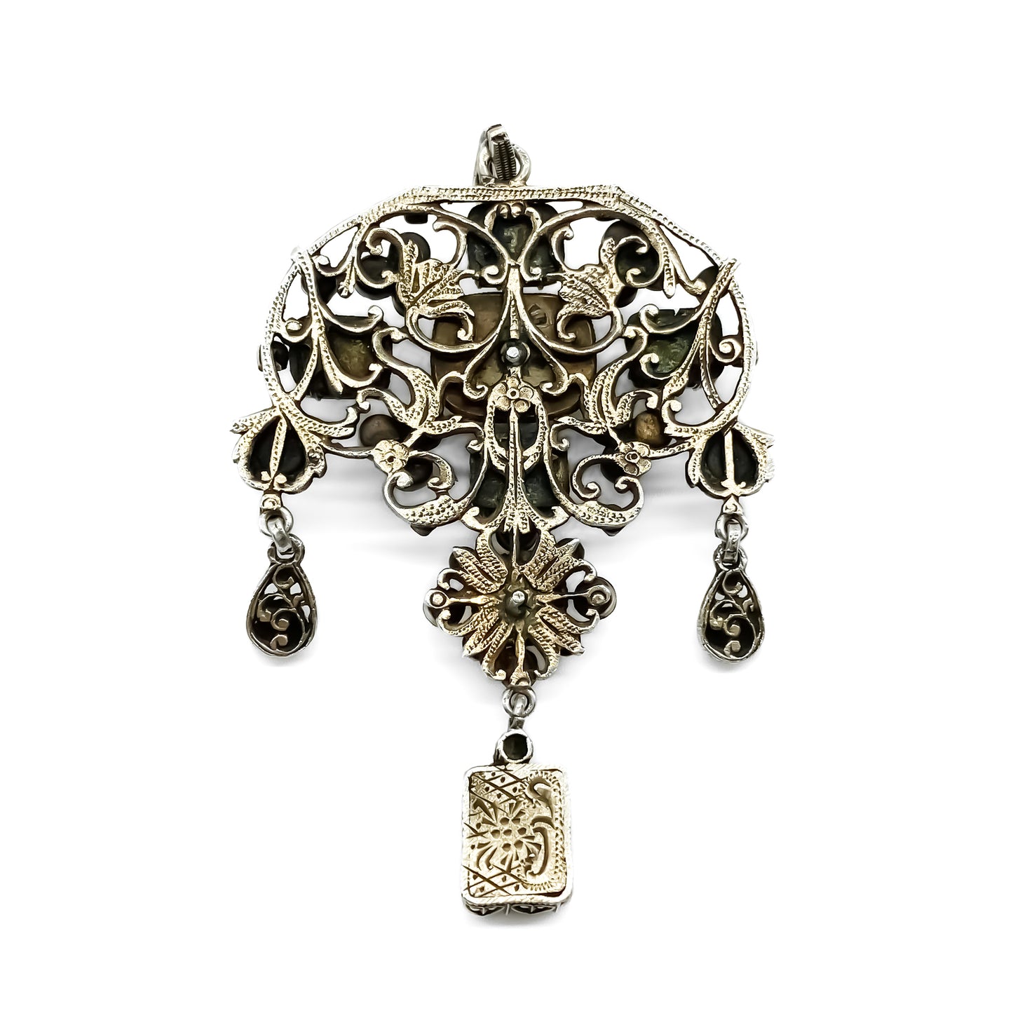 Very ornate silver gilt Austro-Hungarian Festoon pendant set with garnets, seed pearls, emeralds and other green stones. Pendant has beautiful engraving and floral detail.  Circa 1890