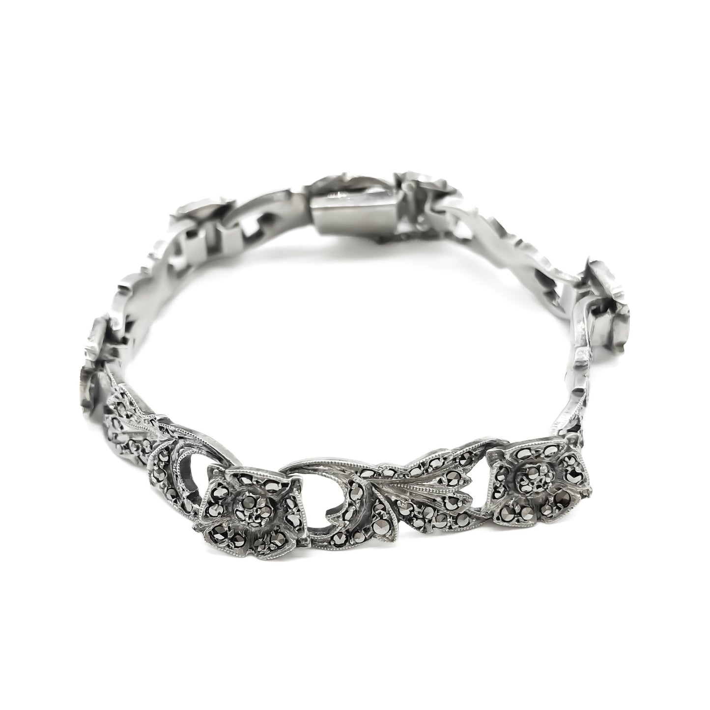 Pretty silver bracelet with marcasites set in a floral design. Bracelet has a safety chain. Circa 1930’s
