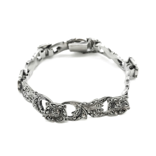 Pretty silver bracelet with marcasites set in a floral design. Bracelet has a safety chain.   Circa 1930’s