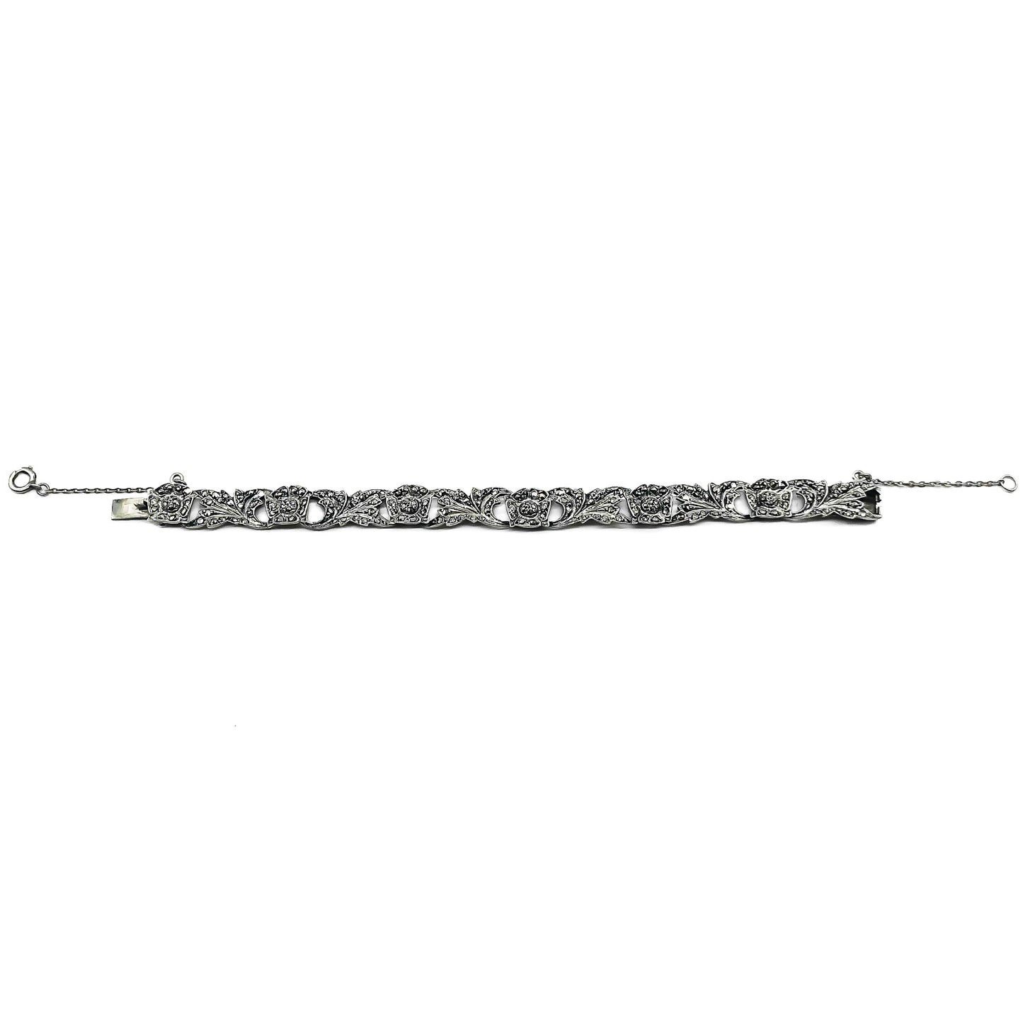 Pretty silver bracelet with marcasites set in a floral design. Bracelet has a safety chain. Circa 1930’s