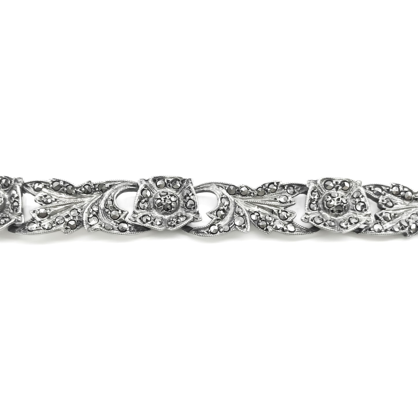 Pretty silver bracelet with marcasites set in a floral design. Bracelet has a safety chain. Circa 1930’s
