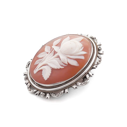 Unique silver brooch/pendant set with a beautifully carved rose cameo surrounded by marcasites. Circa 1930s