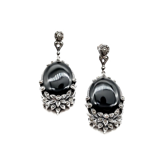 Stunning vintage silver drop earrings, each set with an oval onyx cabochon stone and marcasites in a floral design.