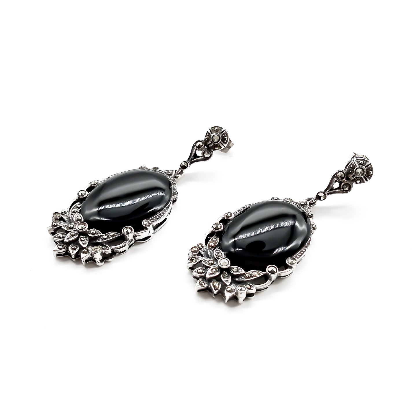 Stunning vintage silver drop earrings, each set with an oval onyx cabochon stone and marcasites in a floral design.